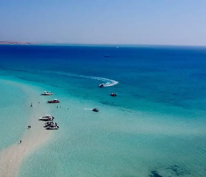 Private boat Hurghada tour anchoring at Abu Minqar Island shallow lagoon.